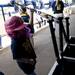 Natalie Harper returns a softball bat to a bin in the Michigan dugout on Saturday, May 4. Daniel Brenner I AnnArbor.com